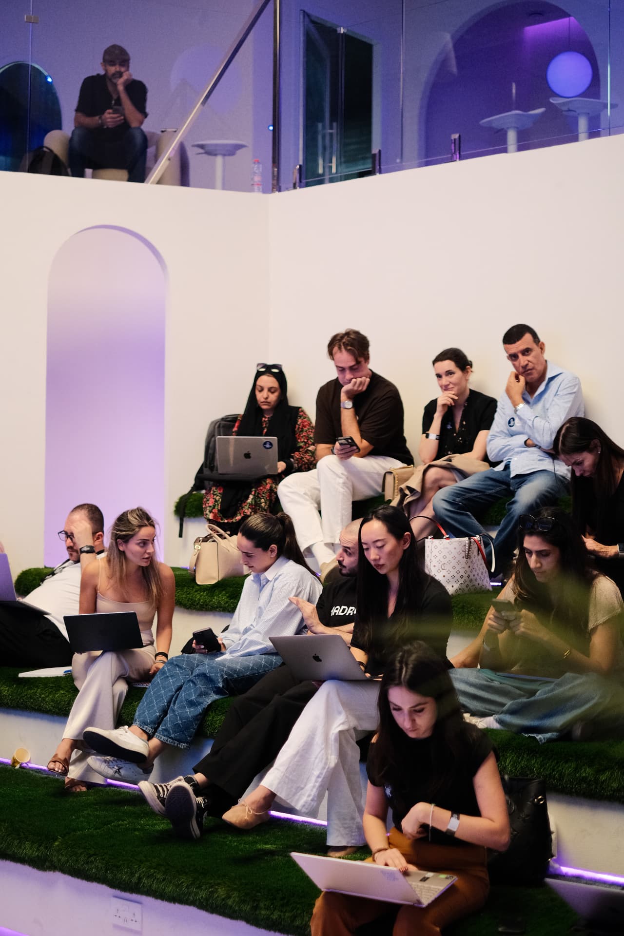 Women learning together with laptops at a Girls Who AI session